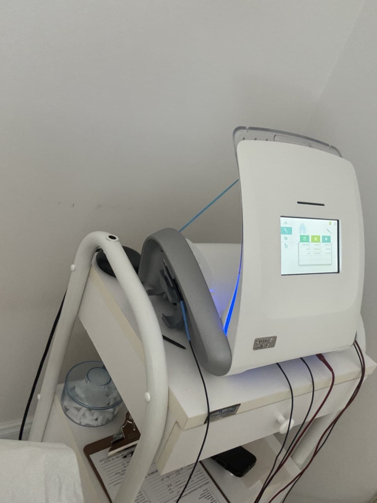 A full electrolysis clinic setup with the machine, articulating arm, and magnifier lamp.